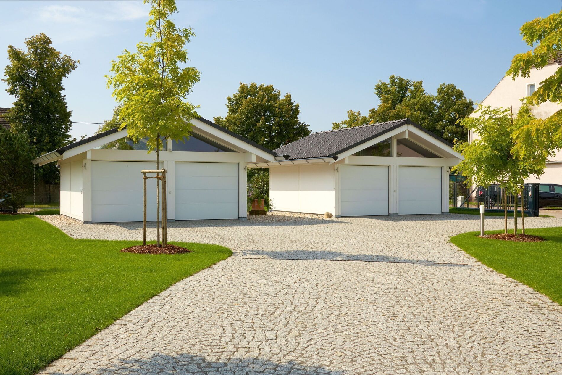 Modernes Fachwerkhaus mit Garagen und grünem Garten