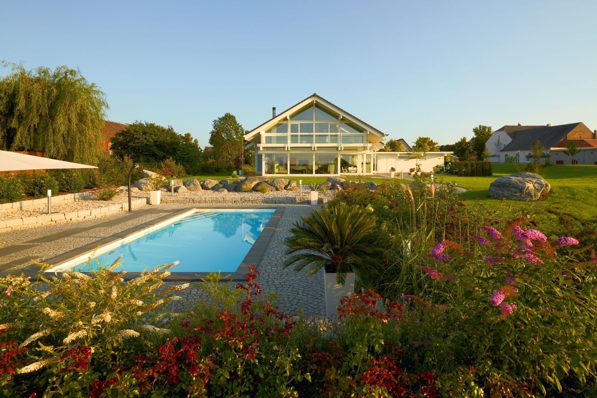 Modernes HUF HAUS ART 4 mit Pool und Gartenlandschaft