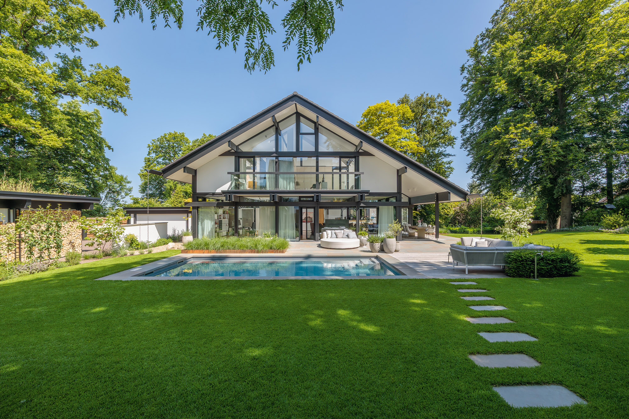 Architektenhaus mit Garten und Pool, zeitloses Design.