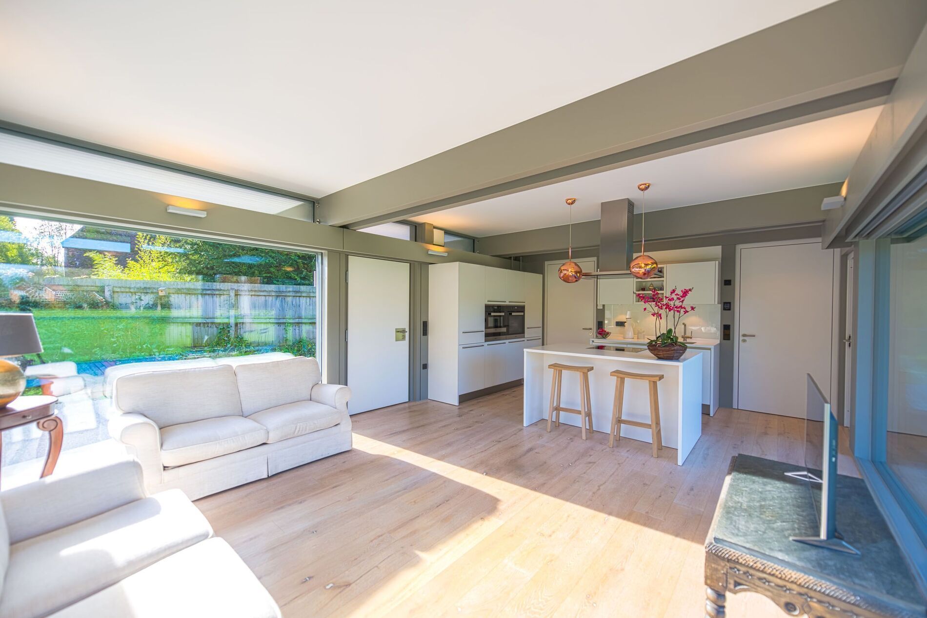 Stilvoller HUF Anbau mit modernem Wohnraum Helles Wohnzimmer mit offener Küche in einem HUF Anbau
