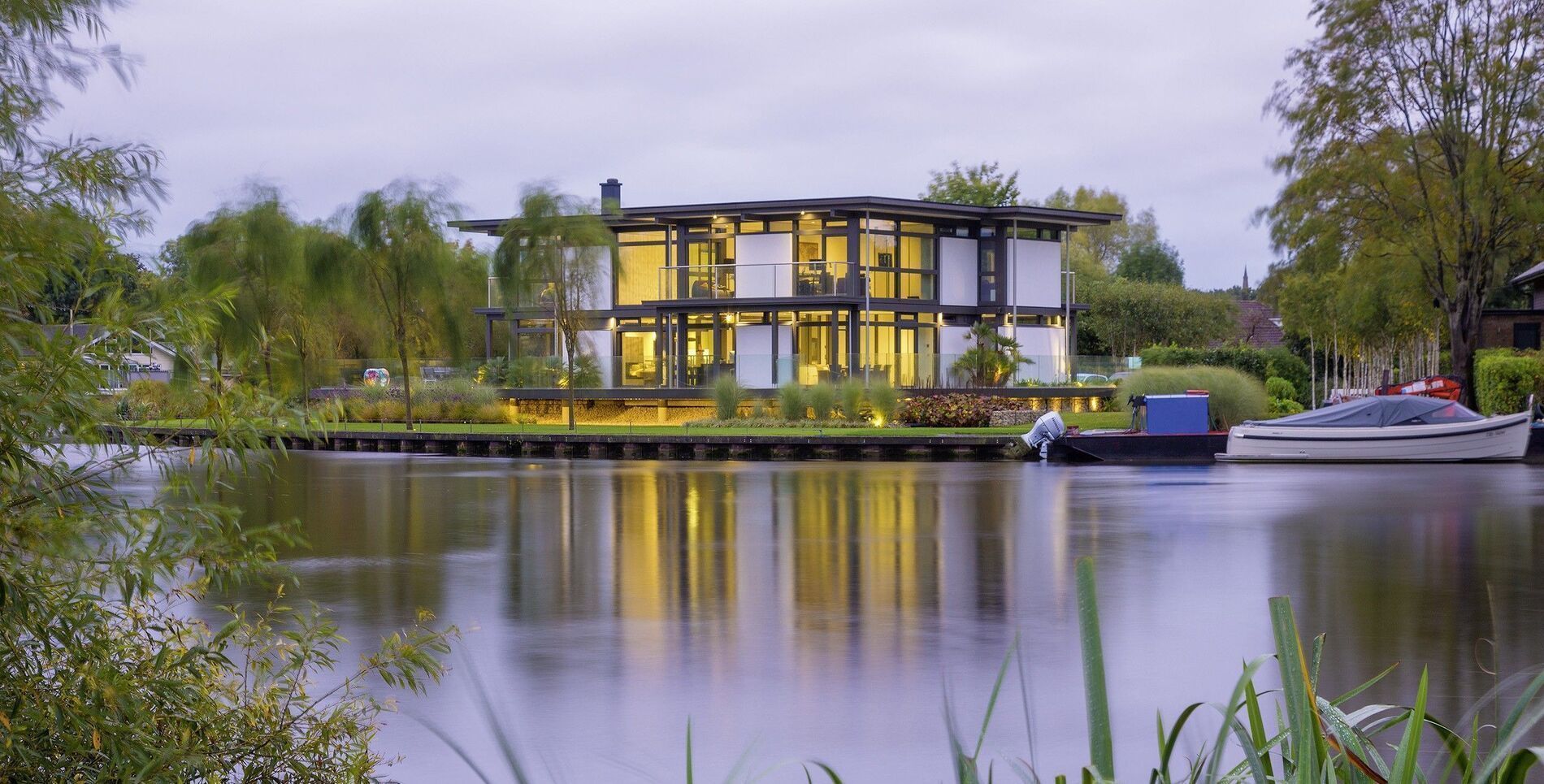 Contemporary architecture reflecting on a calm water surface