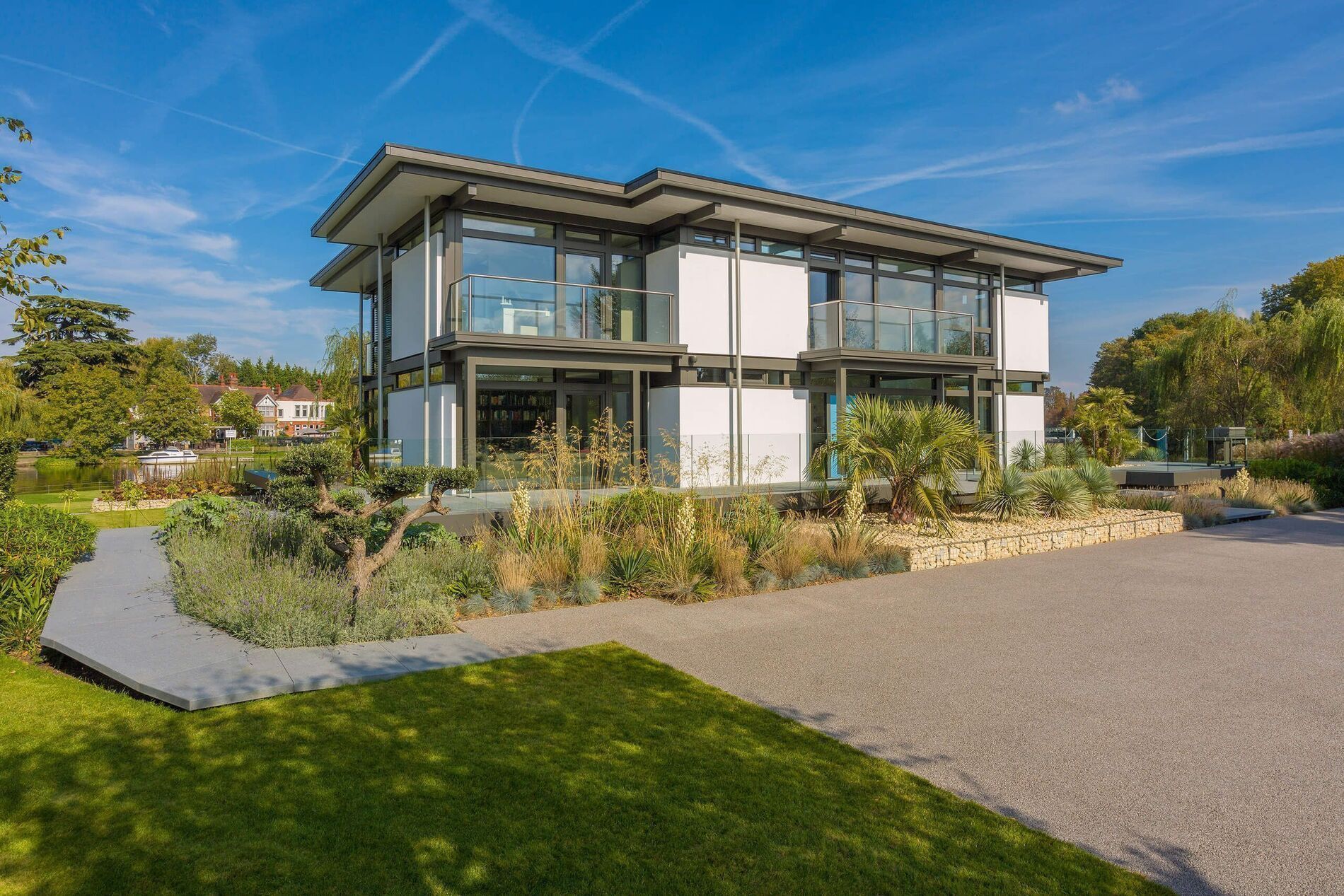 Moderne Architektur mit Garten und Parkplatz vor dem Haus