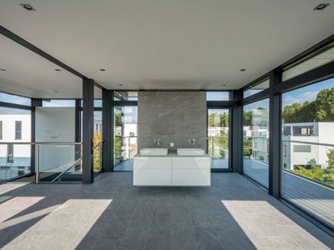 Modernes Interieur eines aufgestockten Hauses Heller Wohnraum mit großen Fenstern und stilvollem Waschbecken