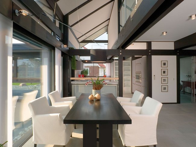 Stylish dining area featuring a black table and white chairs.