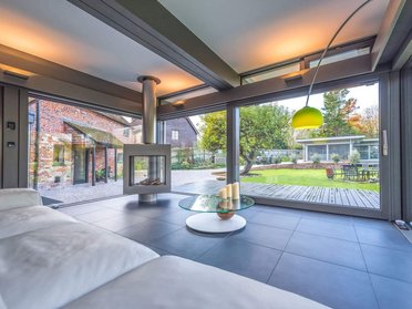 Moderne Architektur mit Kamin und Blick ins Grüne