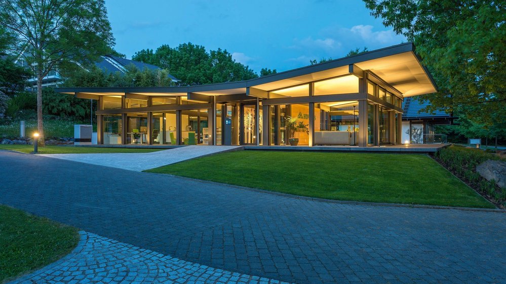 Ein elegantes Gebäude mit großzügigen Glasflächen und eingerichteten Gärten