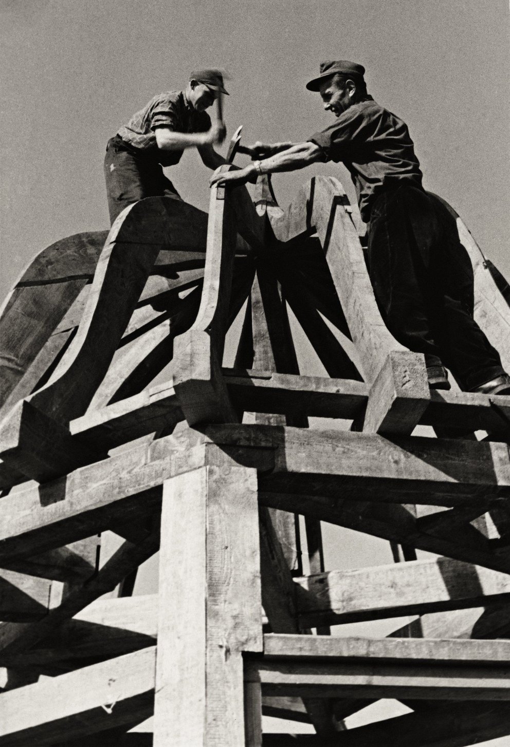 Bauarbeiten an einem historischen Glockenturm Arbeiter montieren eine Glocke auf einem Holzgerüst