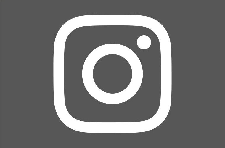 Iconic logo of Instagram in white on gray background