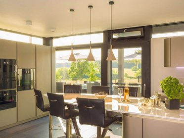 Helle moderne Küche mit Blick auf die Landschaft und zeitgemäßer Einrichtung
