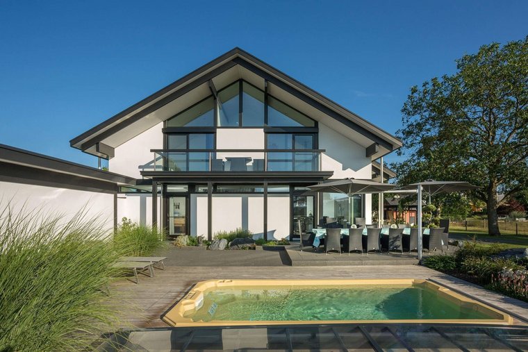 Ein modernes Haus mit Glasfront, Terrasse und Schwimmbecken