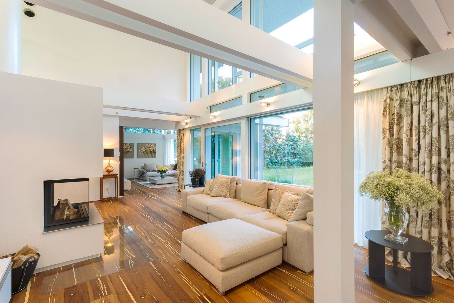 Helles Wohnkonzept mit offenen Räumen und modernem Design Ein lichtdurchfluteter Wohnbereich mit modernem Sofa und Kamin.