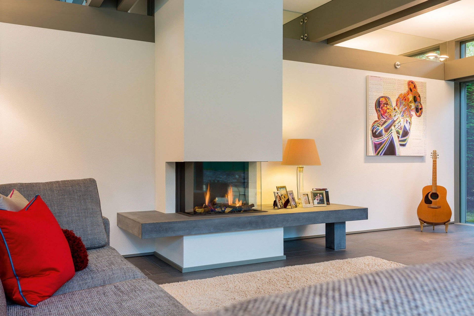 Cozy interior featuring a fireplace, soft seating, and artwork