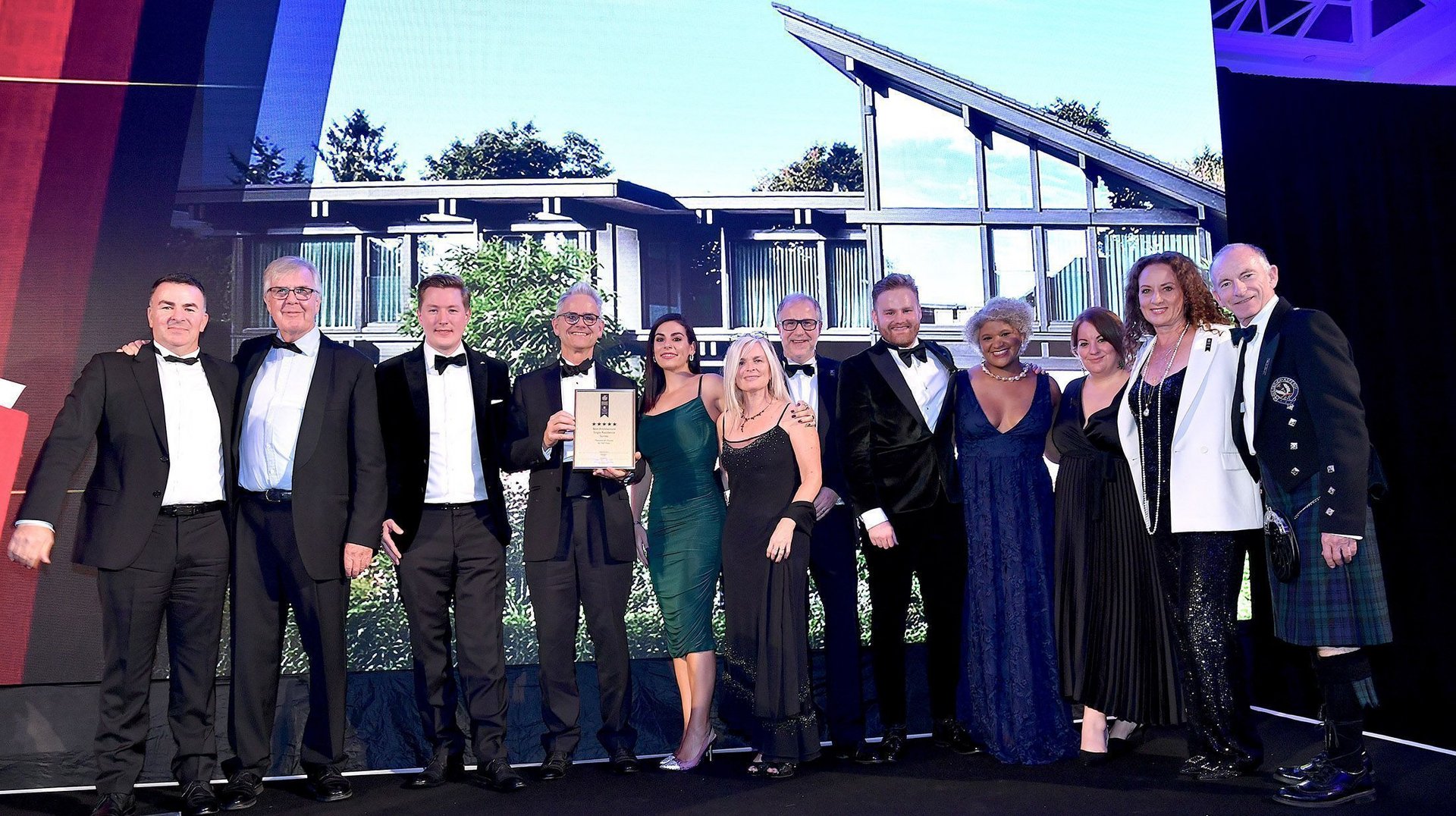 Gruppenbild bei Preisverleihung Ein Team posiert stolz mit einem Preis bei einer Veranstaltung